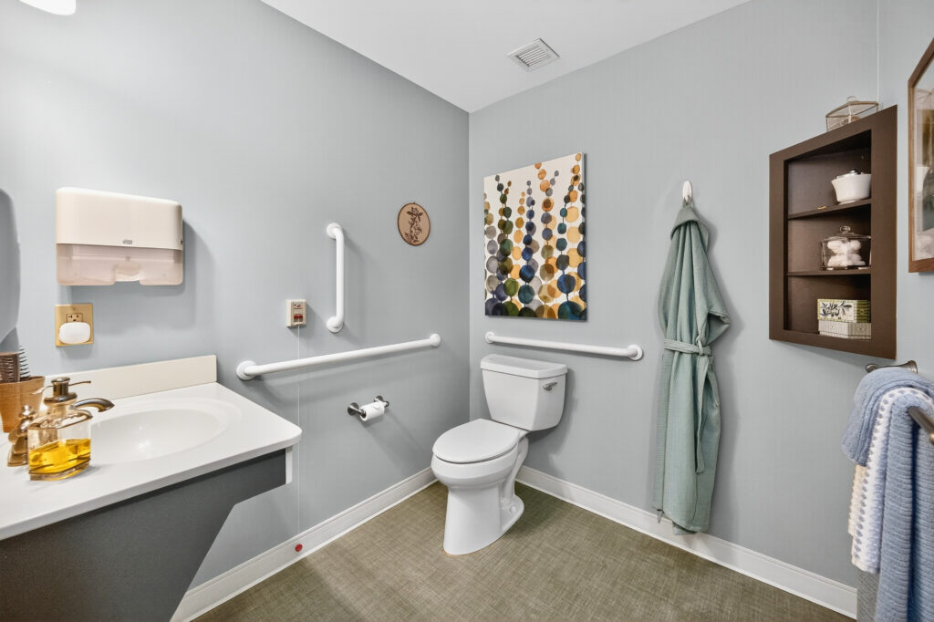 A well lit studio suite model bathroom featuring decorative home accents